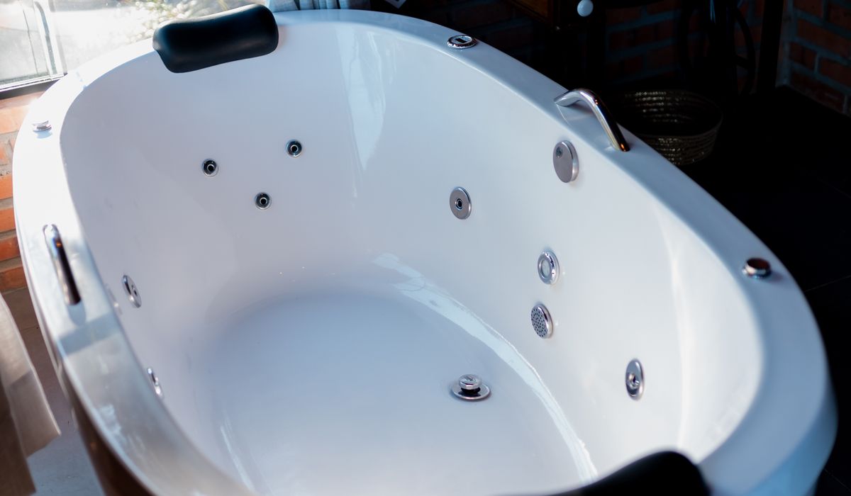 Empty white acrylic whirlpool shell with jets — restoration surface
